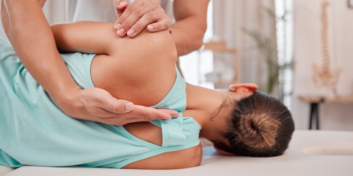 Doctor, chiropractor and woman with back pain for physiotherapy from a physiotherapist helping with spine alignment. Rehabilitation and chiropractic worker healing a healthy girls spinal posture