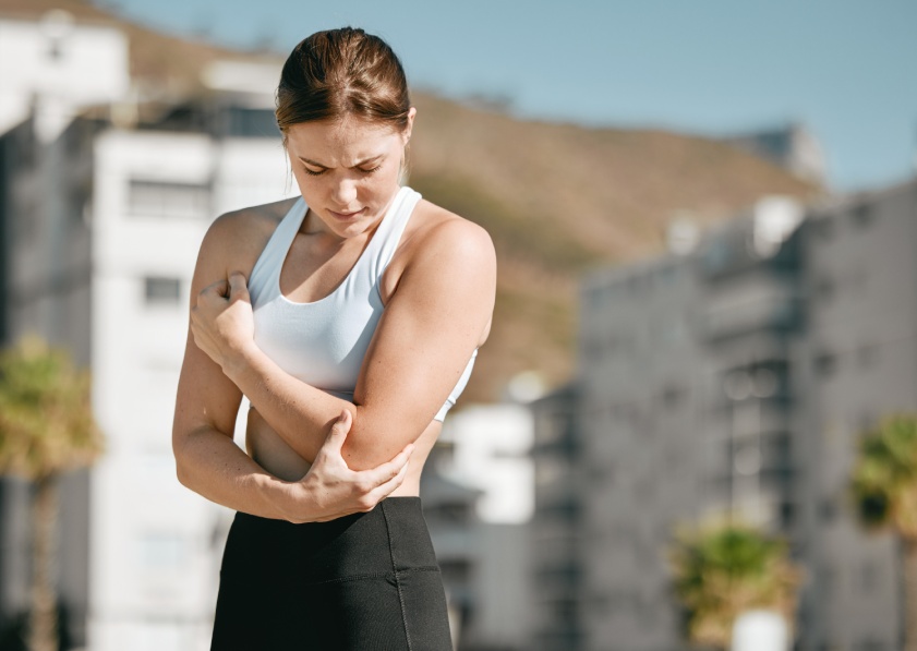 Injury, fitness and woman with arm pain after running, broken bone and sprain after exercise in city. Accident, sports and athlete runner with a body accident, muscle strain and injured with mockup