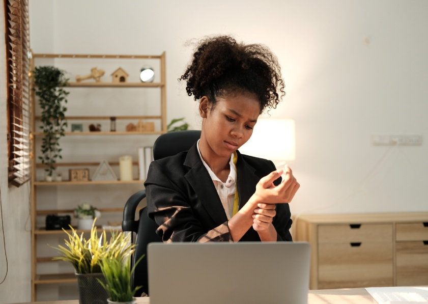 African american woman business worker suffering for wrist pain working at office