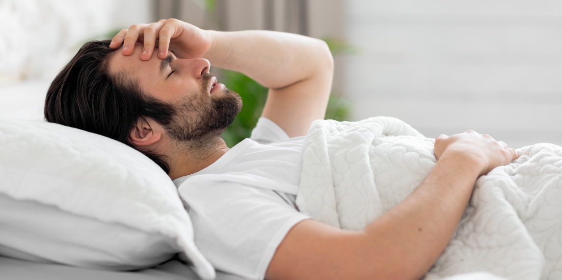 Side,View,Of,Upset,Bearded,Young,Man,In,Pajamas,Waking